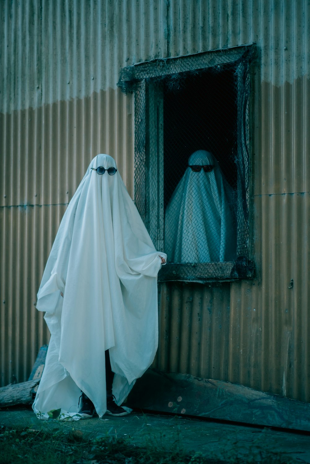 a person in a ghost costume looking out of a window