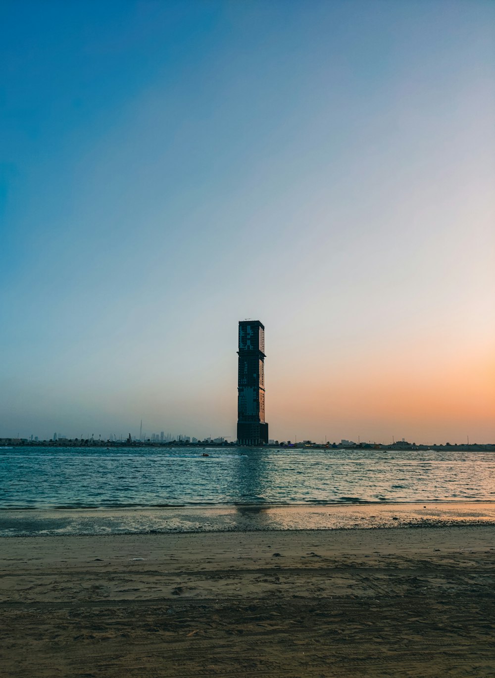 a tall tower sitting in the middle of a body of water