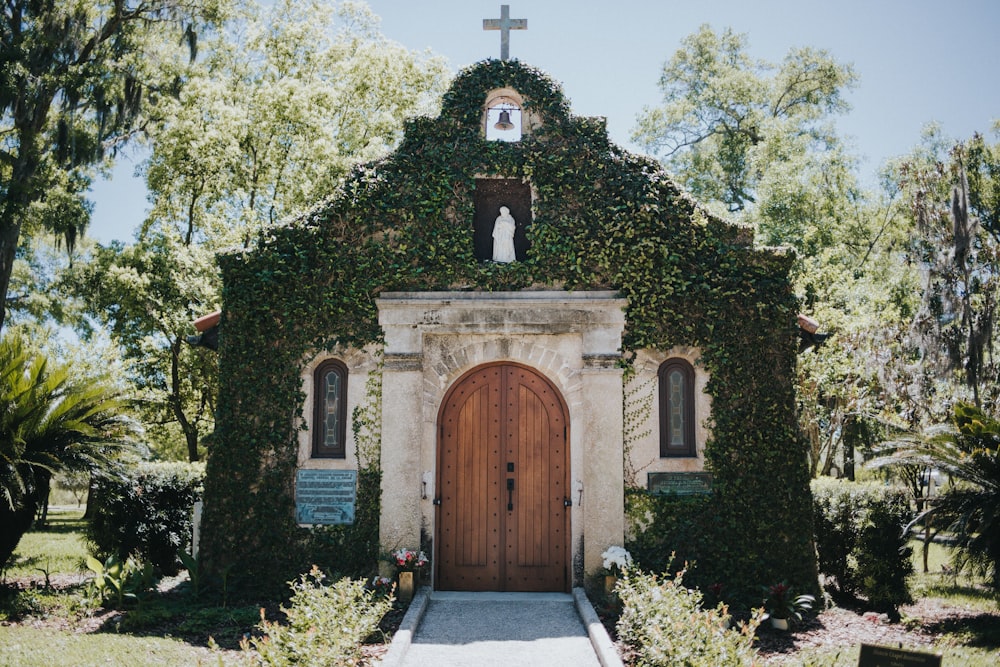 a small church with a cross on top of it