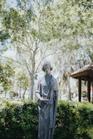 Elegant statue of the goddess of justice holding scales, set against a neutral background.
