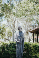 Elegant statue of justice with blindfold, set against a serene mountain landscape.