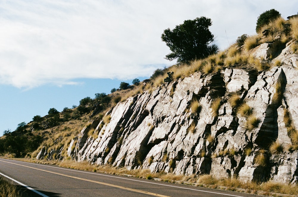 a large rock formation on the side of a road