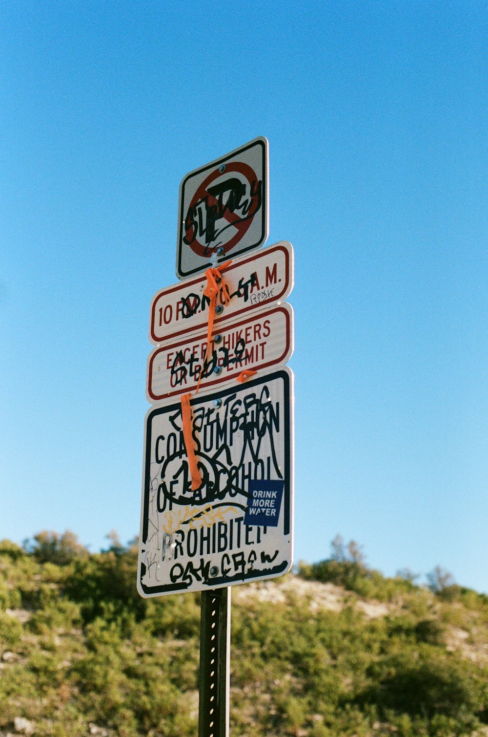 a pole with a bunch of street signs on top of it