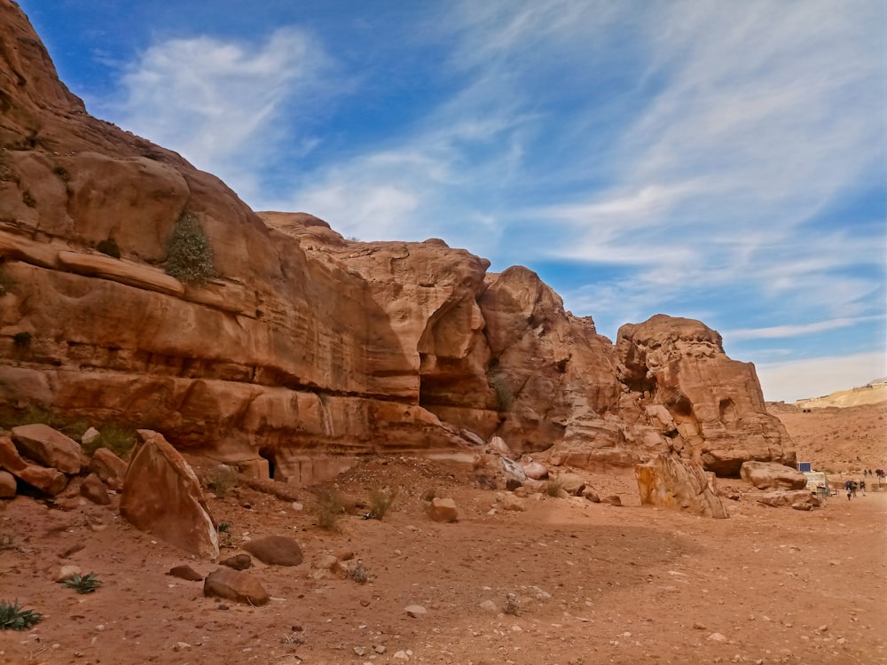 a group of people standing in the middle of a desert