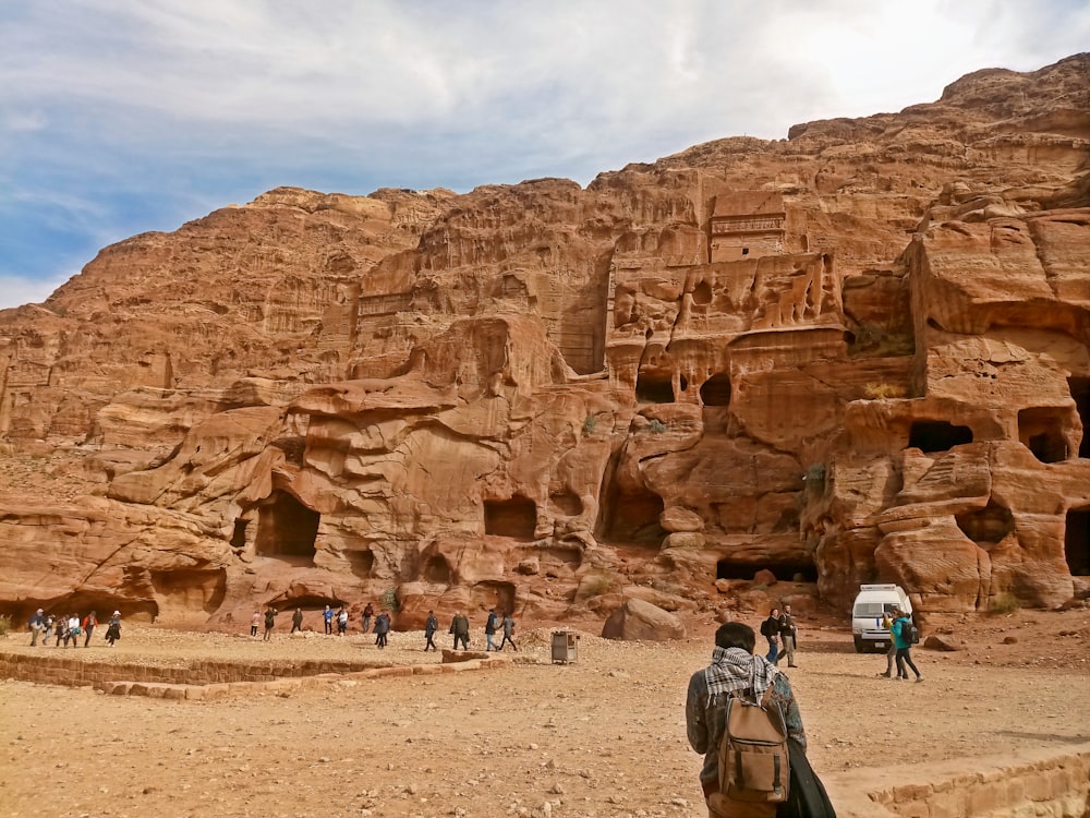 a group of people standing in front of a mountain