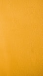 a close up of a yellow painted wall