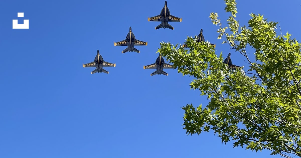 A Group Of Fighter Jets Flying Through A Blue Sky Photo Free United a-group-of-fighter-jets-flying-through-a-blue-sky-photo-free-united