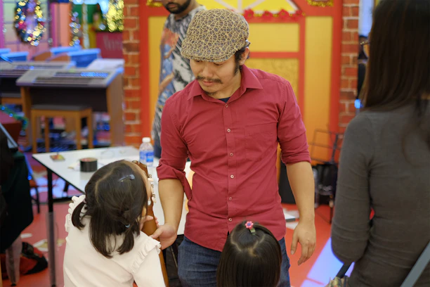 Kakinada Rajesh warmly interacting with a family receiving aid from Deva Foundation.
