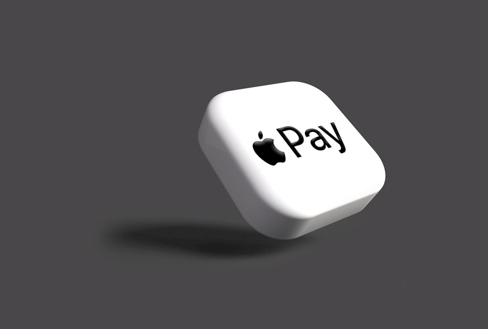 a white dice with the word pay on it