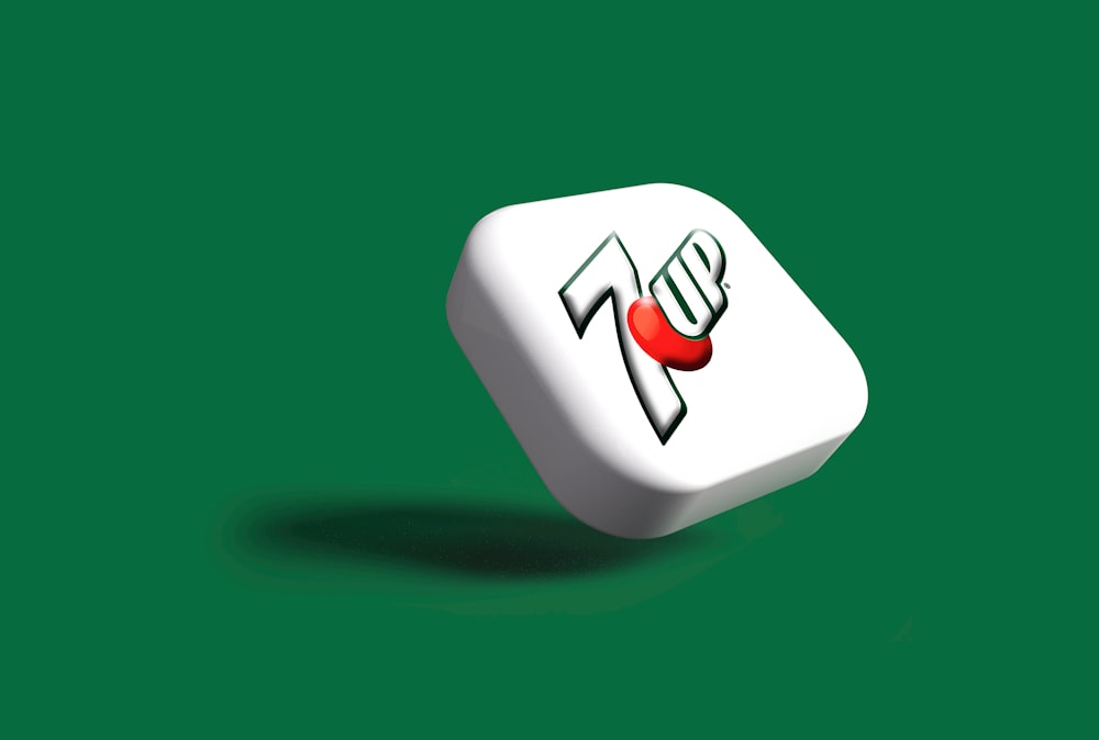a white dice with a red heart on it