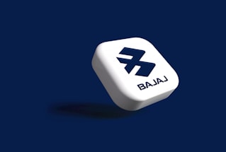 A floating, white, rounded square shape with a stylized 'B' logo and the word 'BAJAJ' on a dark blue background.
