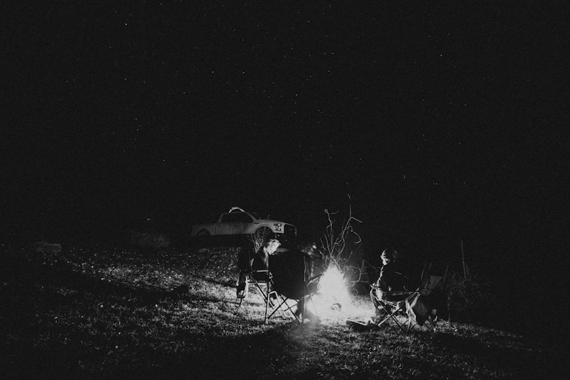 a group of people sitting around a campfire