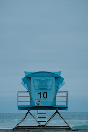 a lifeguard tower sitting on top of a sandy beach