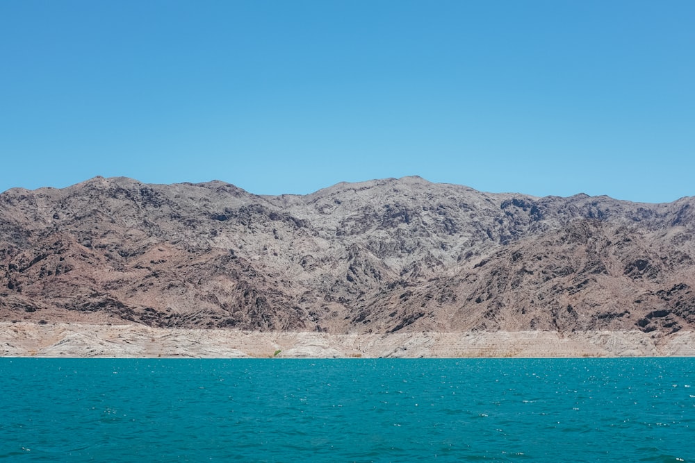 a large body of water with mountains in the background