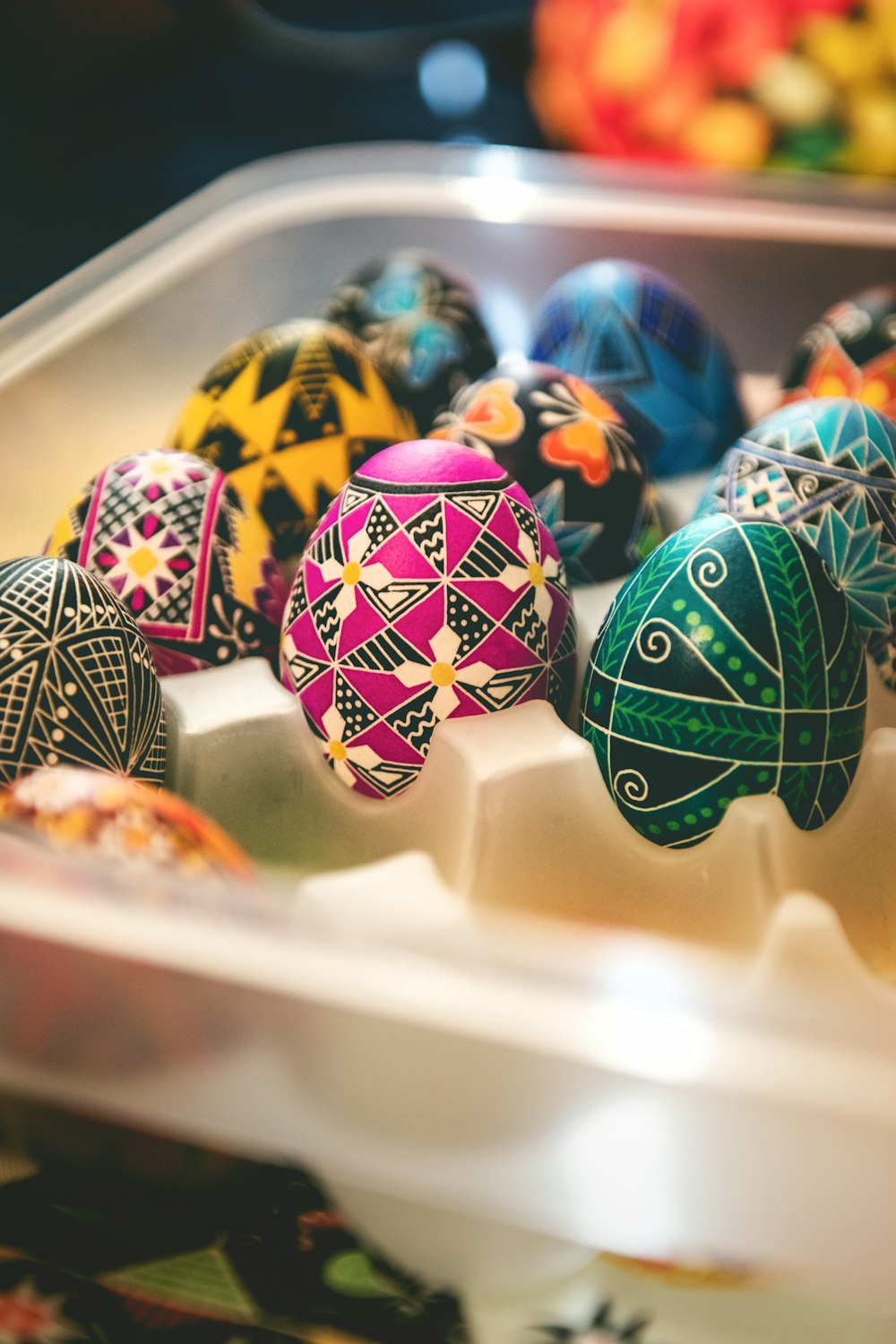 a plastic container filled with different colored eggs