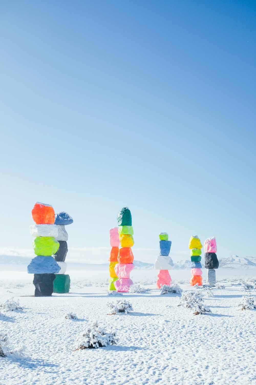 a group of colorful sculptures in the snow