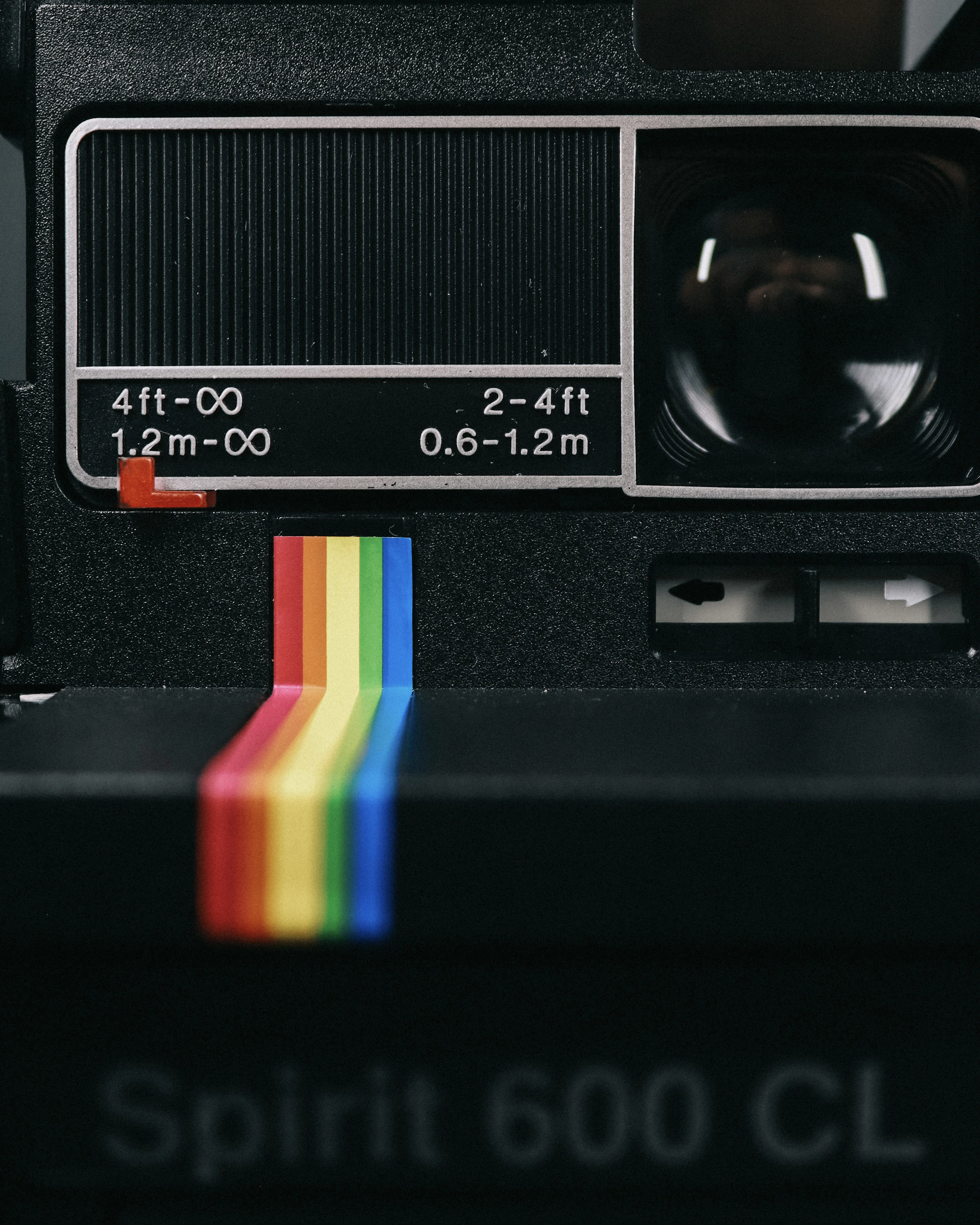 a close up of a camera with a rainbow strip