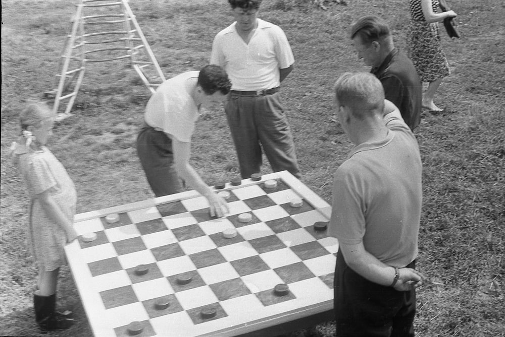 a group of people playing a game of chess