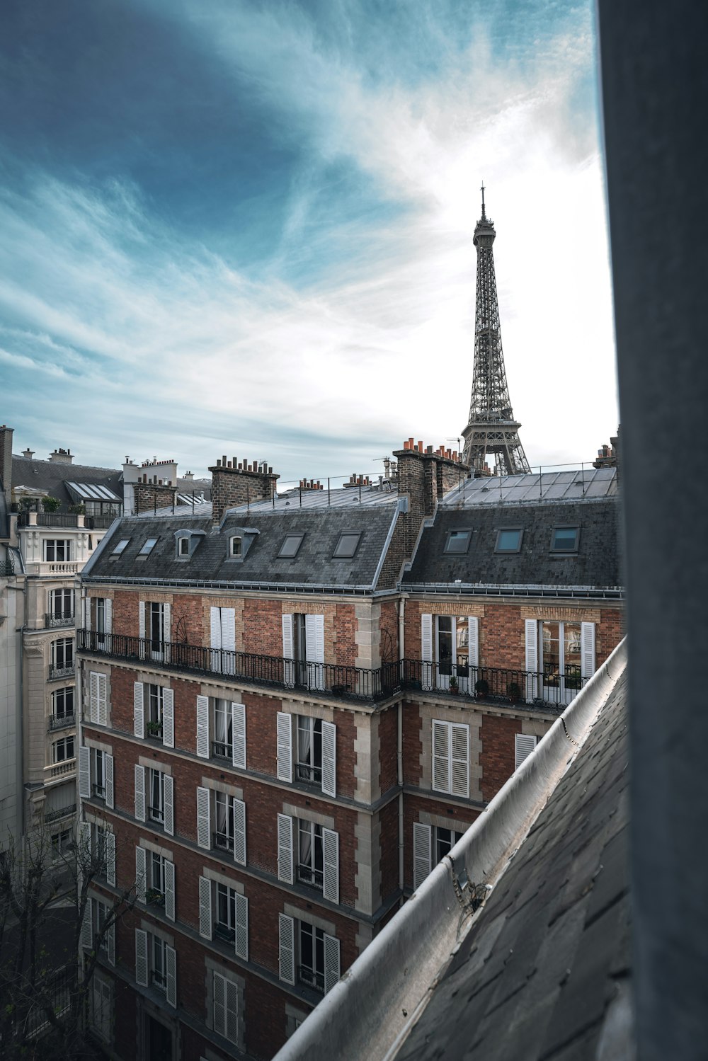 a view of the eiffel tower from the roof of a building