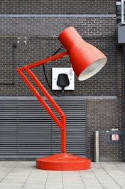 a red lamp sitting on top of a red table