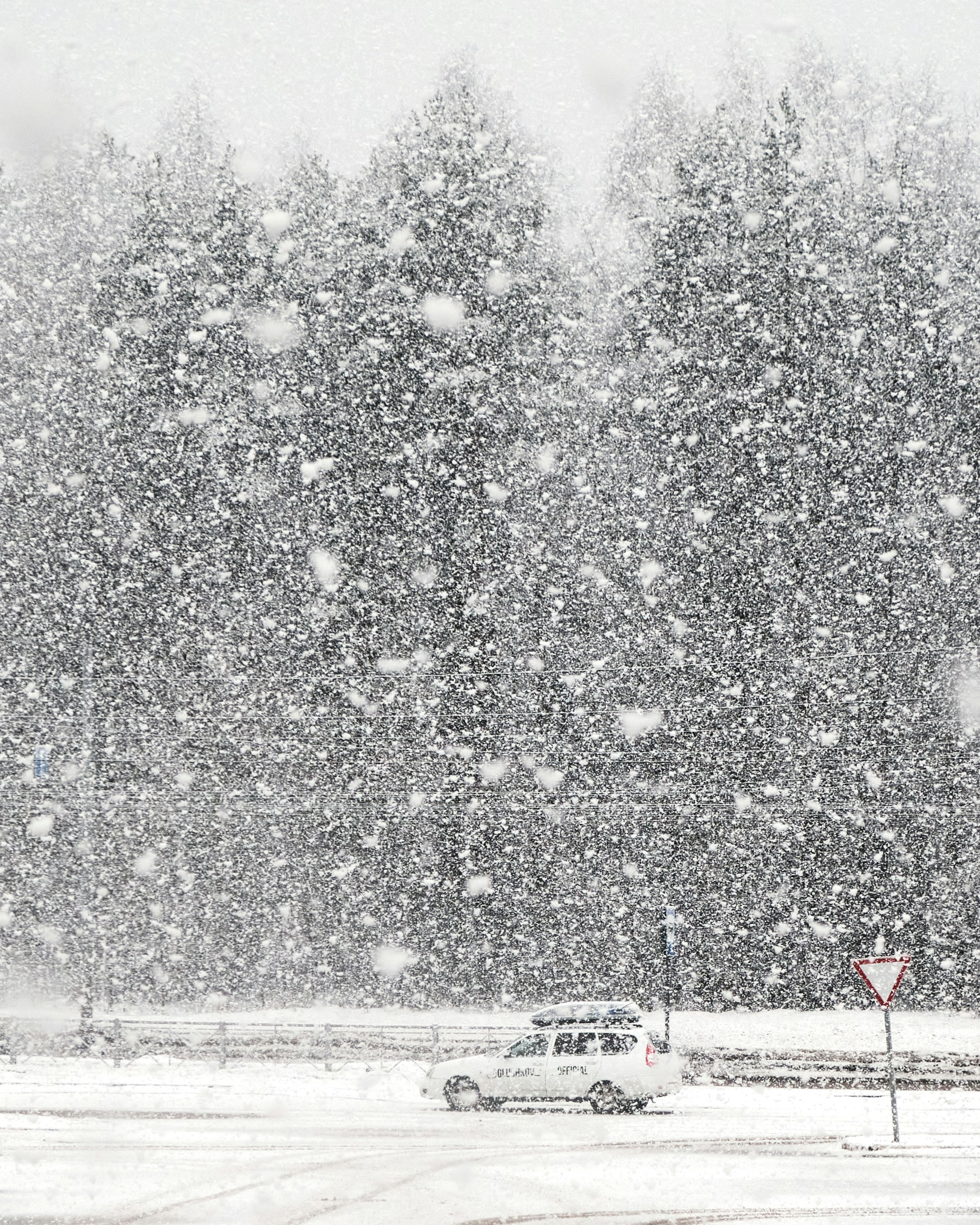 a car driving down a snow covered road
