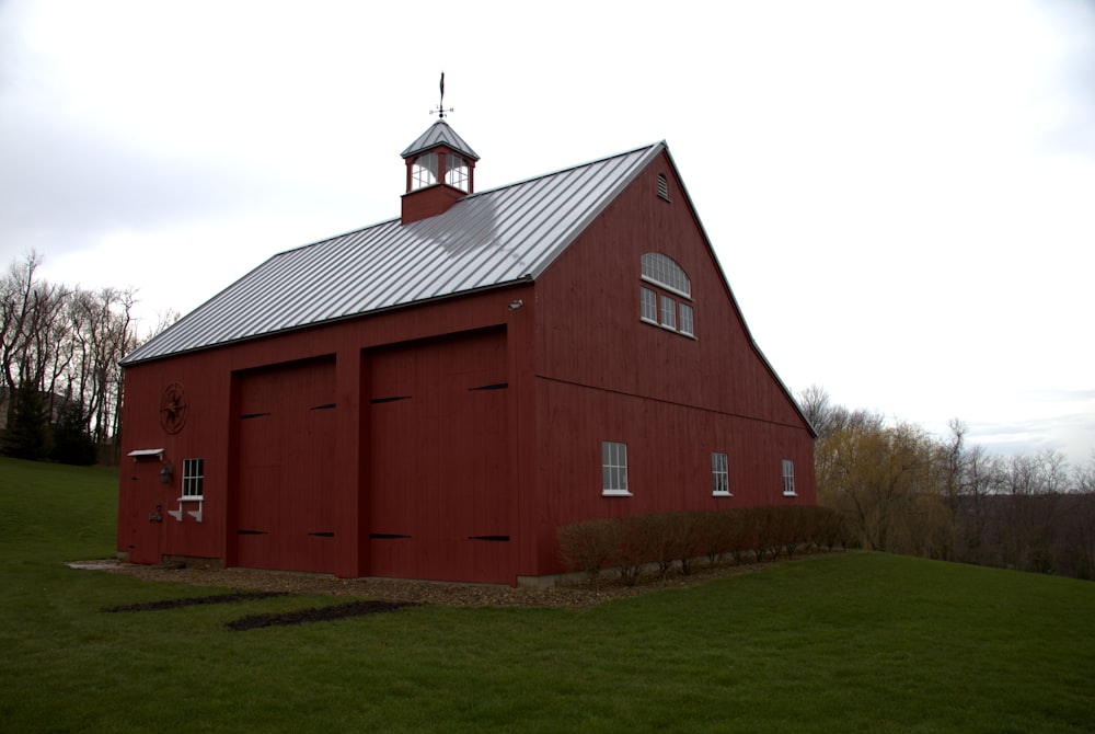 a large red barn with a steeple on top of it