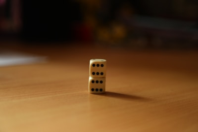 a pair of dice sitting on top of a wooden table