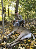 A close-up of hands inspecting a freshly harvested deer, showcasing respect for the land.