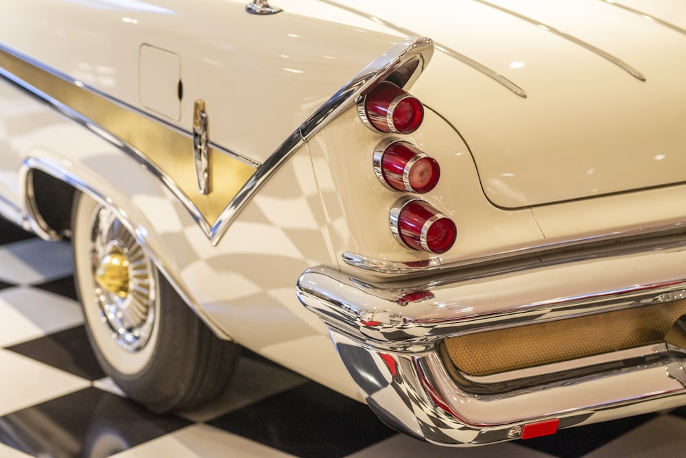 a close up of a classic car on a checkered floor