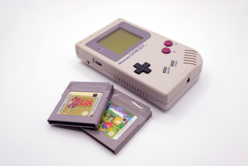 a nintendo game boy with a card and a case