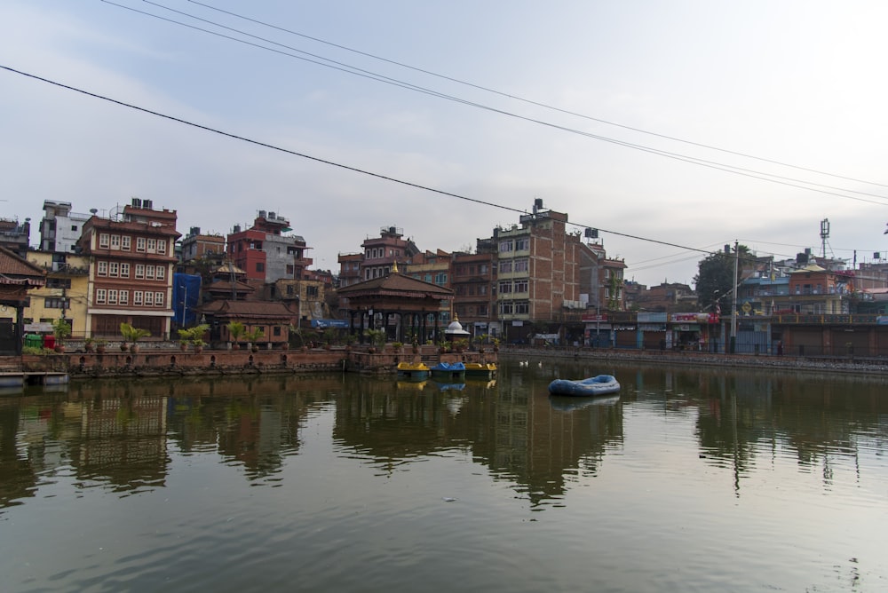 a body of water surrounded by buildings and power lines