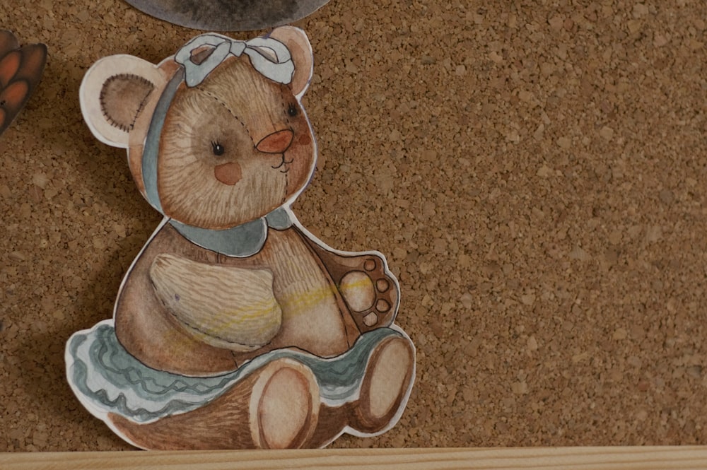 a picture of a teddy bear on a cork board