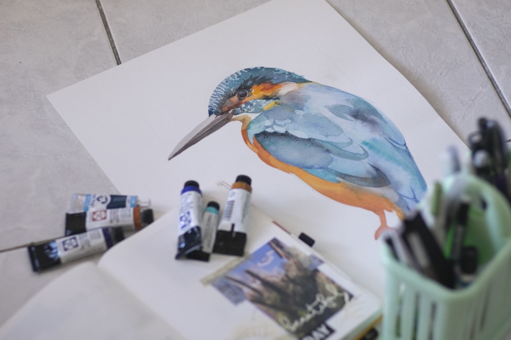 a painting of a kingfisher on a piece of paper