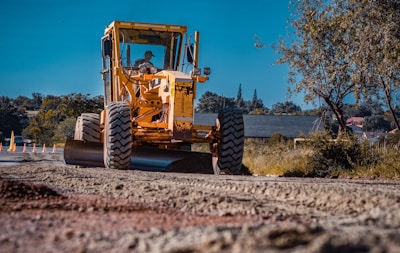 Close-up of a compactor machine smoothing freshly moved earth.