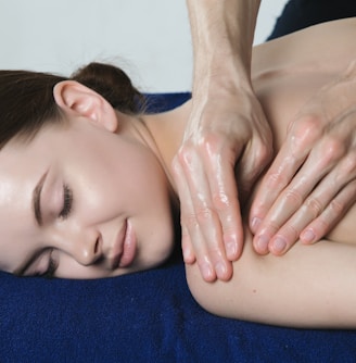 a woman getting a back massage at a spa