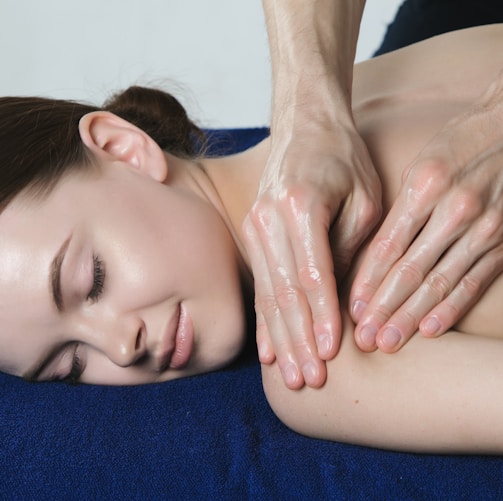 a woman getting a back massage at a spa