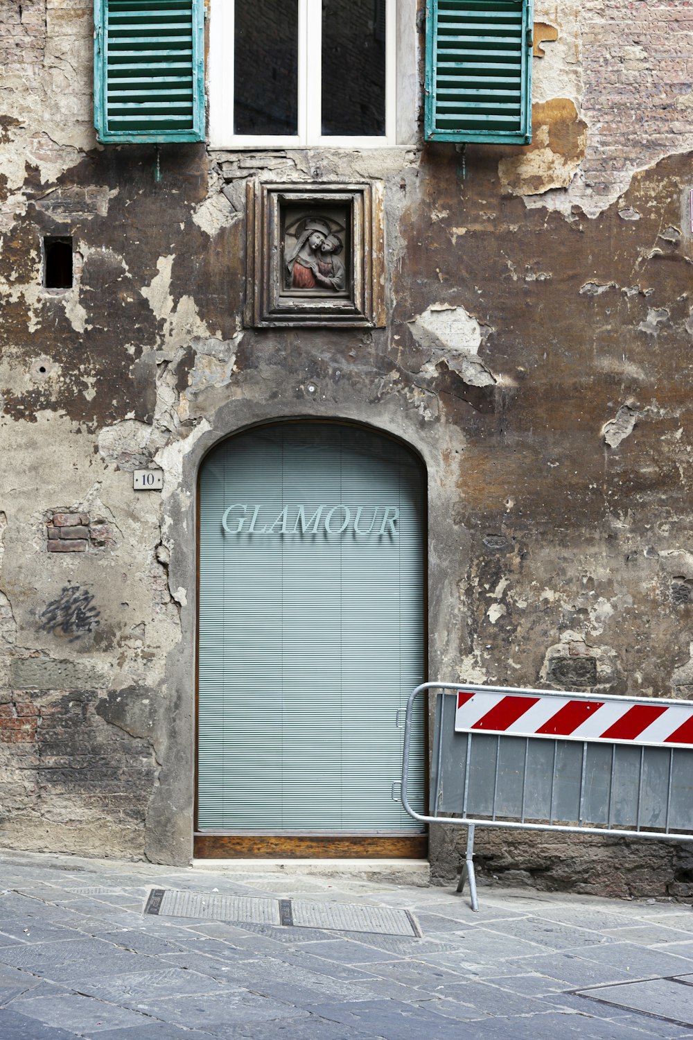 an old building with a blue door and shutters