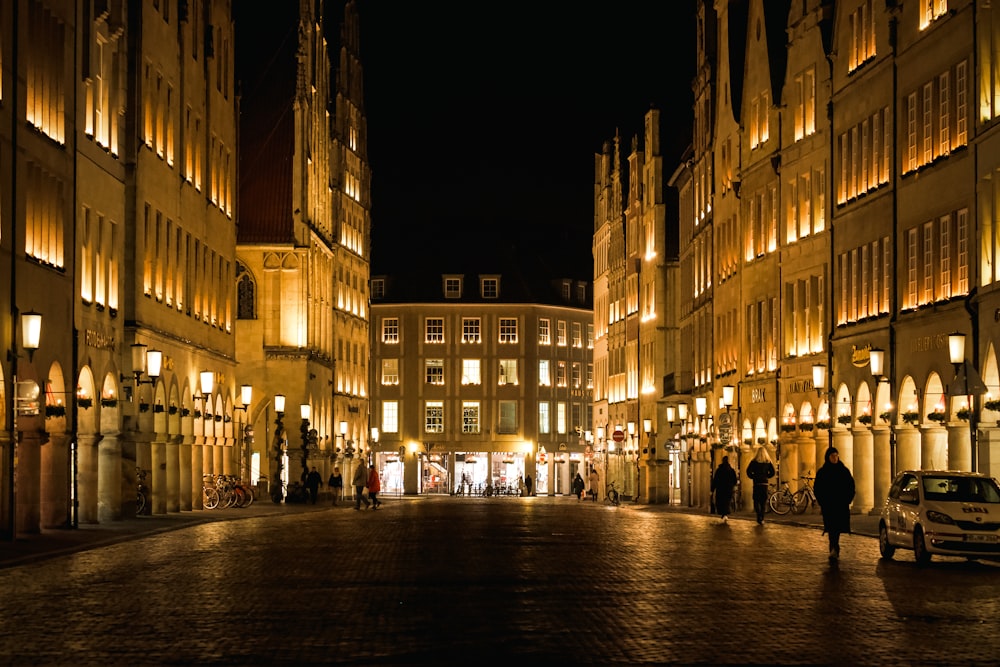 a city street is lit up at night