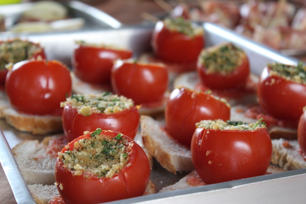 a tray of tomatoes and bread on a table