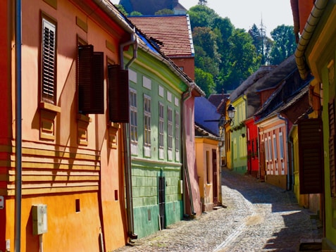 a cobblestone street lined with colorful buildings