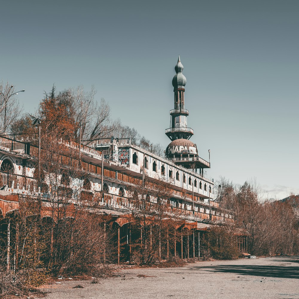 an old abandoned building with a clock tower in the background