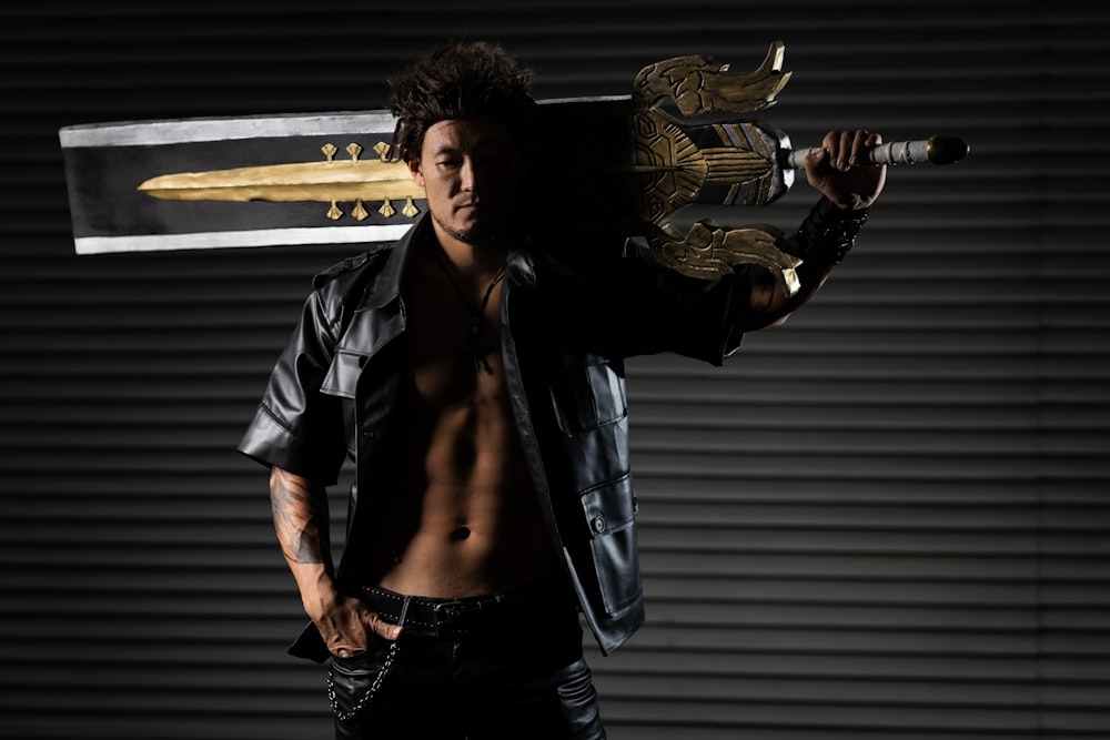 a shirtless man holding a sword in his hand