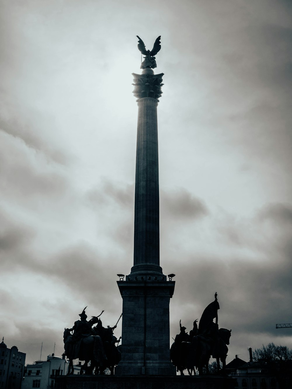 a monument with a statue of an eagle on top of it