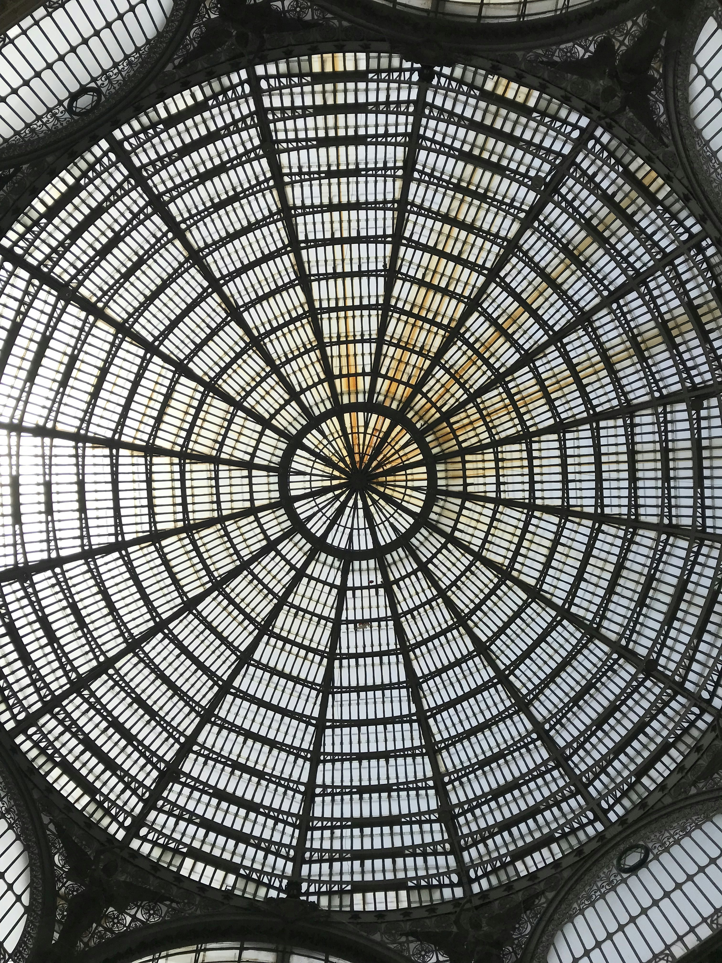 the ceiling of a building with many windows