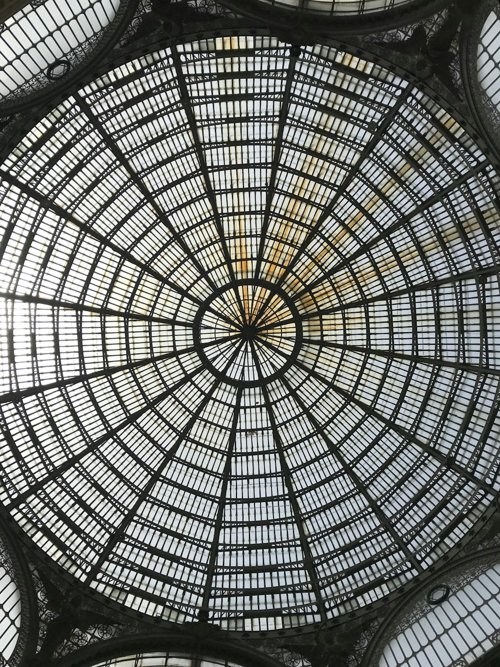 the ceiling of a building with many windows