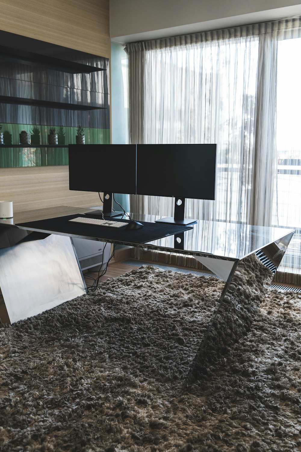 a computer desk sitting on top of a shaggy rug