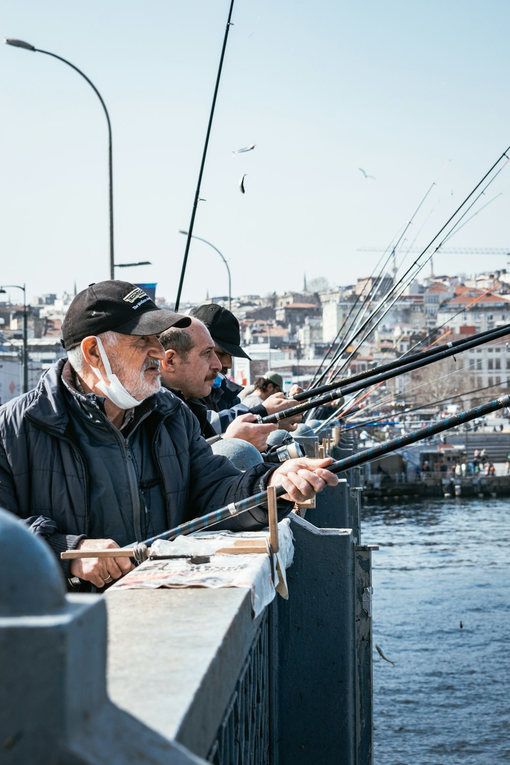 a group of men standing next to each other on a pier