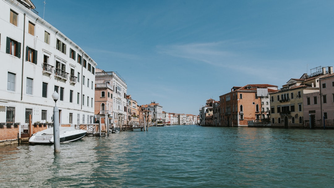 a boat is parked in the water next to a row of buildings