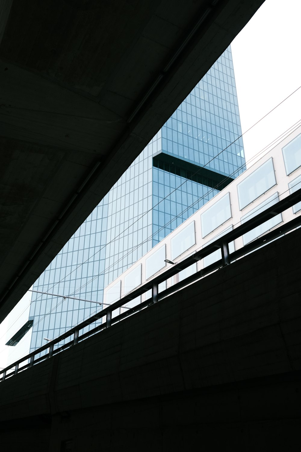 a view of a high rise building from under a bridge