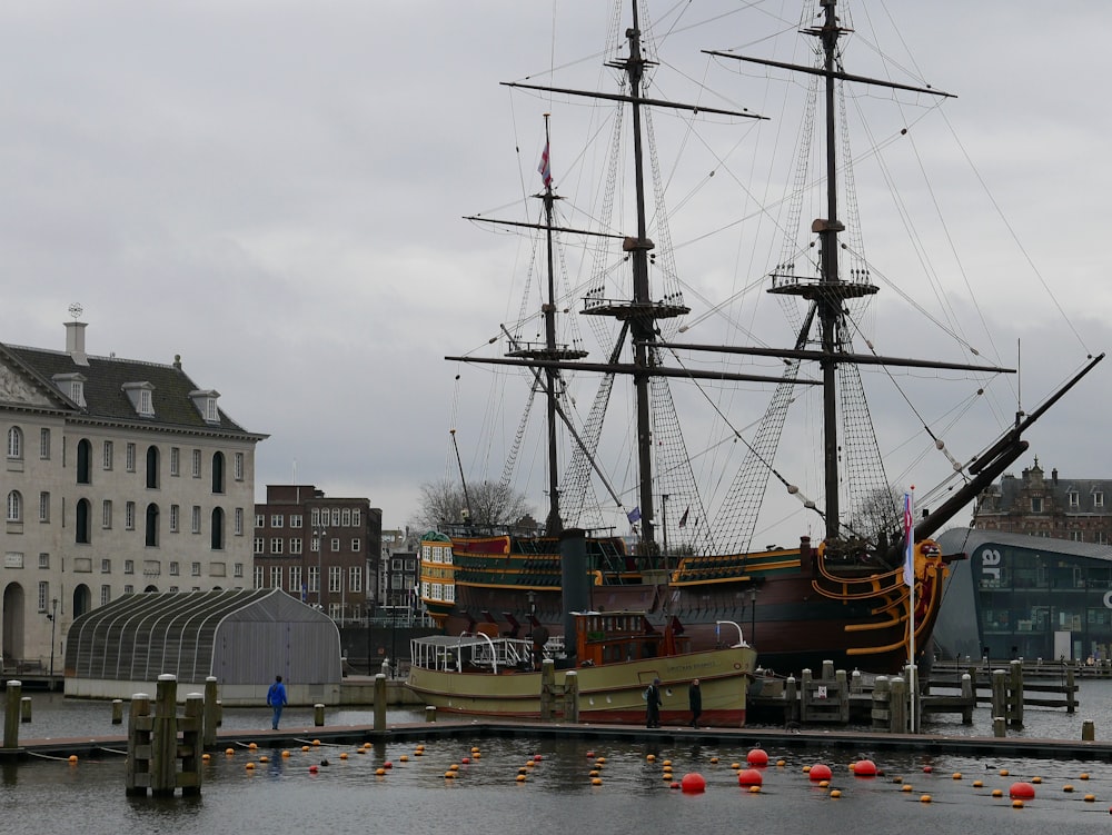 a large boat is docked at a pier